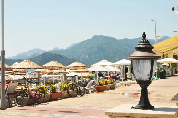 Close Black Street Lantern Bicycles Beach Umbrellas Mountains Backround — Stock Photo, Image