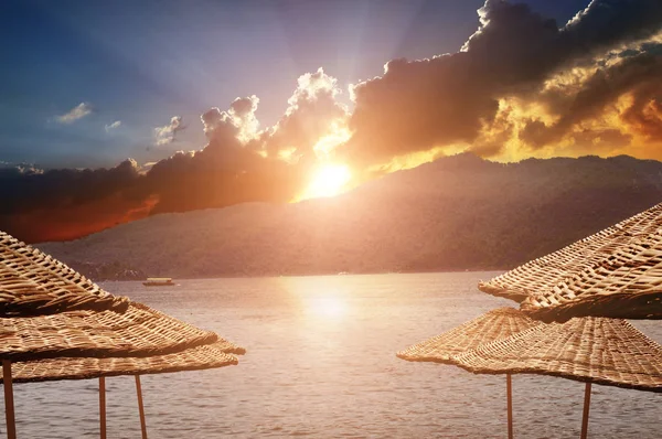 Ambrellas Paglia Sulla Spiaggia Con Mare Montagne Con Foresta Contro — Foto Stock