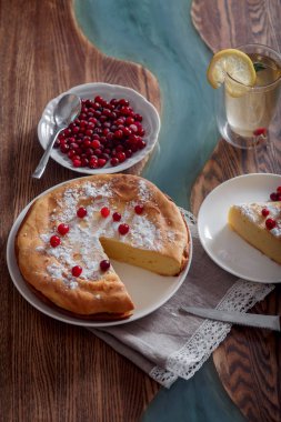 Kızılcık ve şeker, yeşil çay ve ahşap masa üzerinde limon Cheesecake ile Kahvaltı