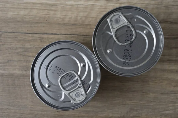 Tin cans for food on wooden background. Top View.