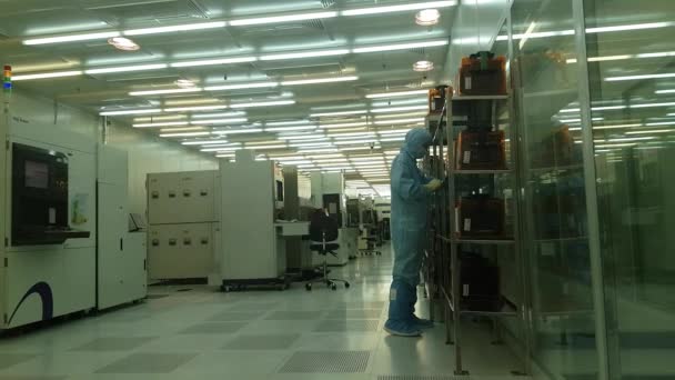 Técnicos de ingenieros en trajes estériles sostienen semiconductor — Vídeos de Stock