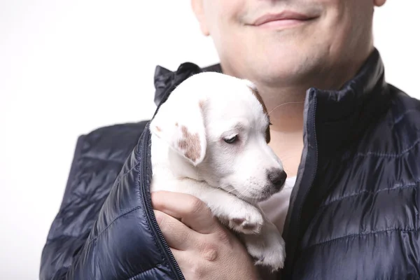 Man holds a puppy in his hands
