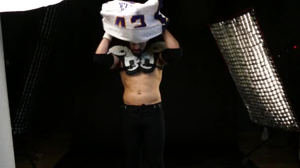 American Football Player wearing his sport dress on Black Background — Stock Video
