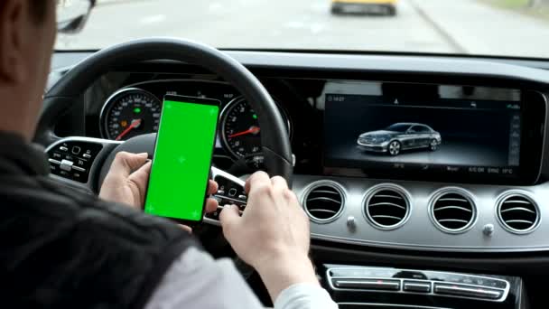 Man hold smartphone in car on dashboard background — Stock Video