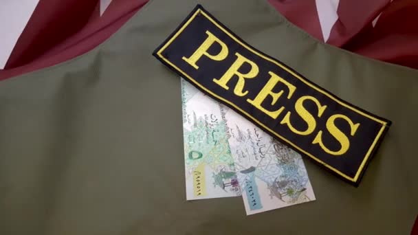 Bulletproof vest and money on the national flag — Stock Video