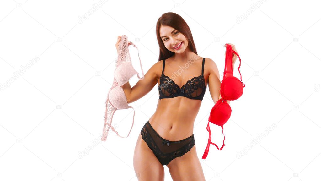 Lingerie, woman holds red and beige bra in her hands, isolated on white,