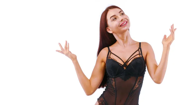 Joyful girl in lacy lingerie looks up waving her arms. — Stock Photo, Image