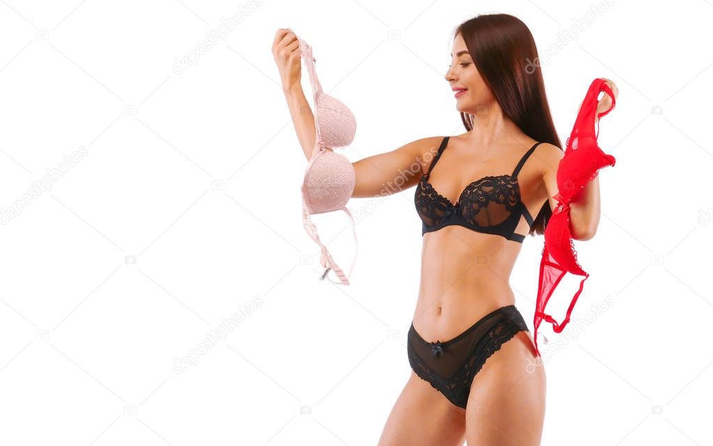 Red and beige bra in brunette woman hands, isolated on white.