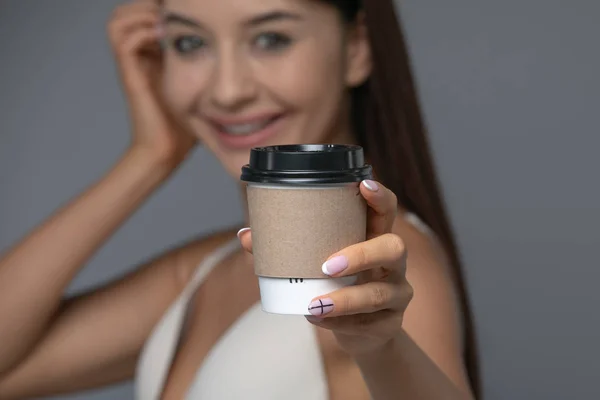 Llevar papel blanco taza de café caliente con la mano derecha celebración . — Foto de Stock