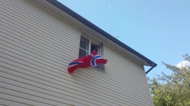 Evdeki pencerede bayrak sallayan gençler