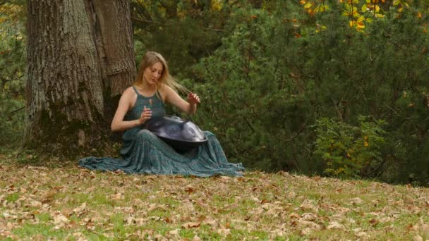 Playing The Instrument Hung. Woman Hands Playing The Hang outdoors. — Stock Video