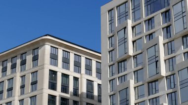 Çok katlı bir apartmanın dış cephesi, pencereleri ve balkonları..