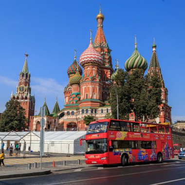 Moscow - September 4, 2018: Red tourist double-decker bus against the background of St. Basil clipart