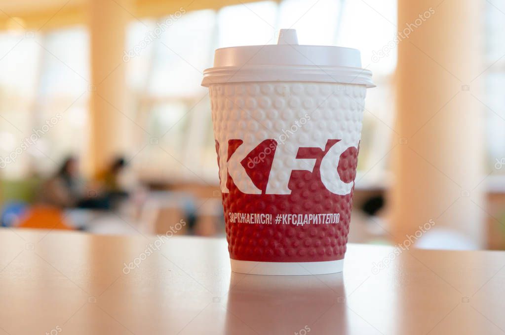 Moscow, Russia, October 11, 2018 : Coffee in paper cups with KFC logo on the table at KFC.