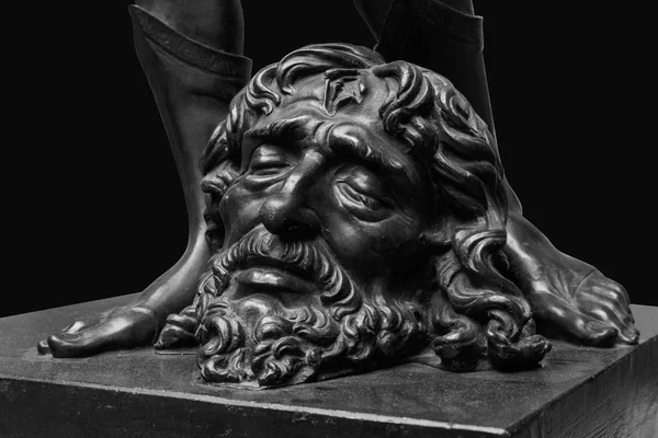 David legs with the Head of Goliath statue isolated on black — Stock Photo, Image