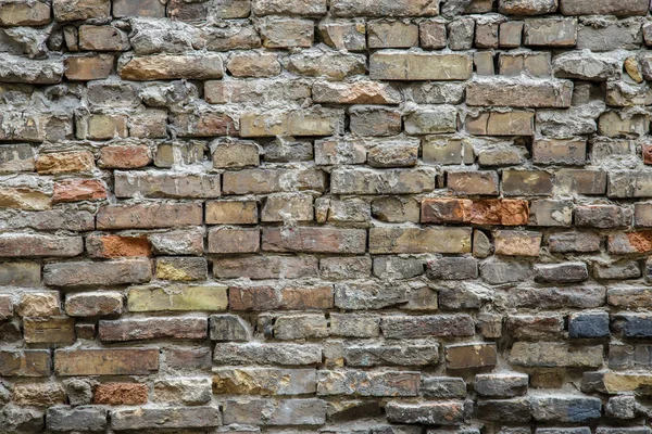 Background of old vintage dirty brick wall with peeling plaster, texture — Stock Photo, Image