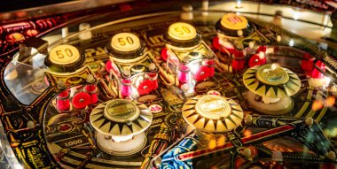 Budapest, Hungary - March 25, 2018: Pinball museum. Pinball table close up view of vintage machine clipart