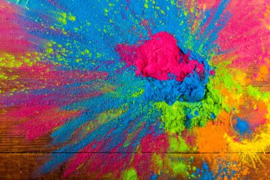 Abstract colorful Happy Holi background. Color vibrant powder on wood. Dust colored splash texture. Flat lay holi paint decoration clipart