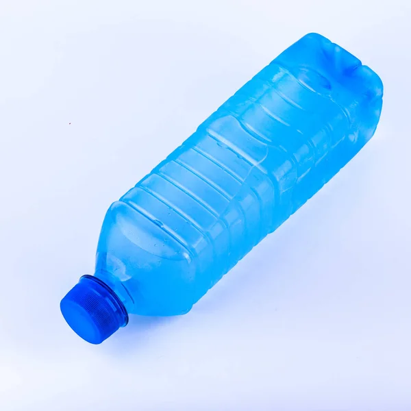 Plastic bottle of drinking water isolated on white background. Transparent blue object — Stock Photo, Image