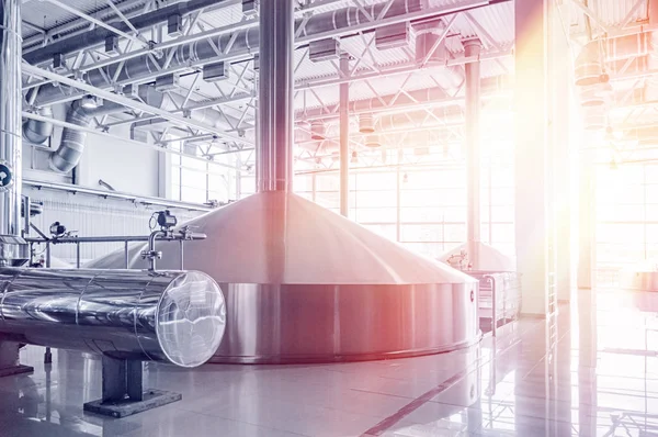 Brewery tank with beer fermentation. Interior of modern brewer manufacture. Factory equipment for beer production. Shiny steel vats. Metallic reservoirs with light leak effect — Stock Photo, Image