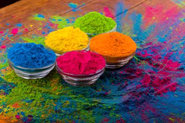 Holi color powder. Organic Gulal colours in bowl for Holi festival, Hindu tradition festive. Bright vibrant pigment closeup clipart