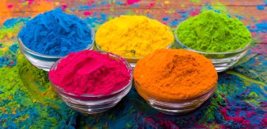Holi color powder. Organic Gulal colours in bowl for Holi festival, Hindu tradition festive. Bright vibrant pigment closeup clipart