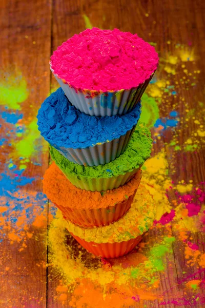 Colorful Holi powder in cups on white rustic wooden table. Top view with copy space — Stock Photo, Image