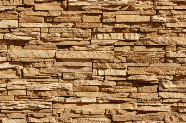Rock stone brick tile wall has a detailed background texture sepia cream brown color stacked in layers, you can use this image as a background image with a texture image — Stock Photo, Image
