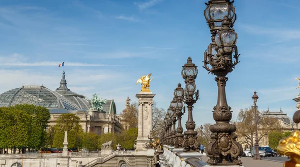 Paříž, Francie, 31. březen 2017: Pont Alexandre III, Paříž, nad řekou Seine. Vyzdobené zdobnými secesní lampami a plastiky. Nejzdobnější, extravagantní most v Paříži — Stock fotografie