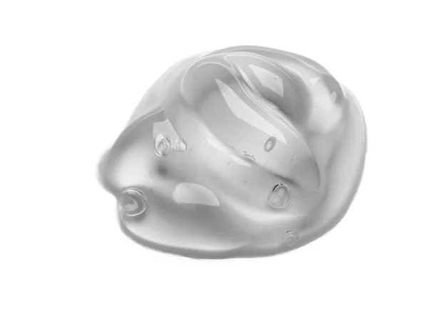 Πιεσμένη καλλυντική διάφανη υφή κρέμας gel Iisolated σε λευκό φόντο. Κοντινό πλάνο φωτογραφία της διαφανούς σταγόνα του προϊόντος φροντίδας του δέρματος. Υψηλής ποιότητας διαφανές τζελ με φυσαλίδες closeup σε λευκό φόντο Εικόνα Αρχείου