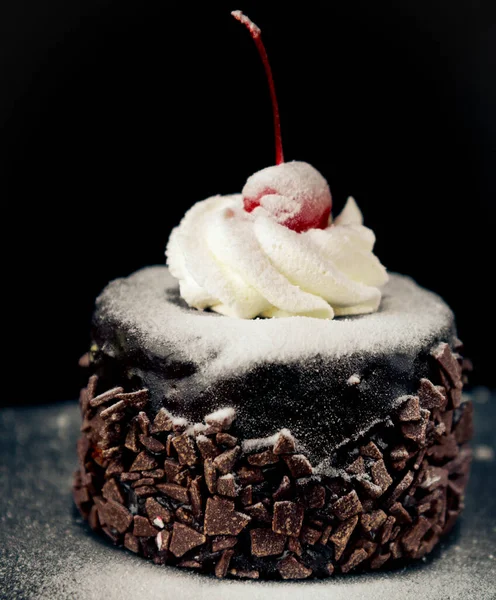 Delicious chocolate cake with cherry on the top icing