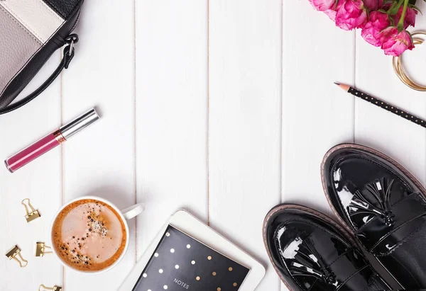 Feminine accessories with shoes, bag and coffee , top view.