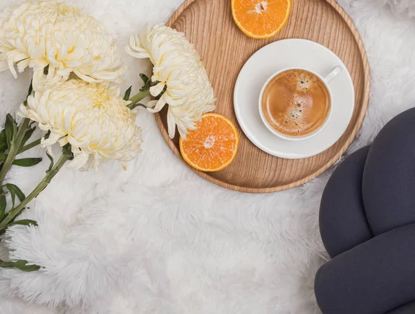 Cozy morning flat lay with coffee, flowers and orange