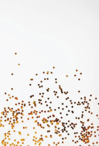 Golden glitter decor on the white background with copy space, — Stock Photo, Image