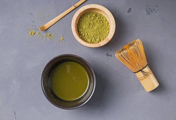 Traditional atcha tea making accessories on the grey color background