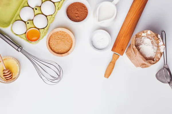 Tools and ingredients for baking: flour, eggs, sugar and other.