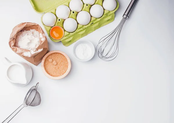 Tools and ingredients for baking: flour, eggs, sugar and other.