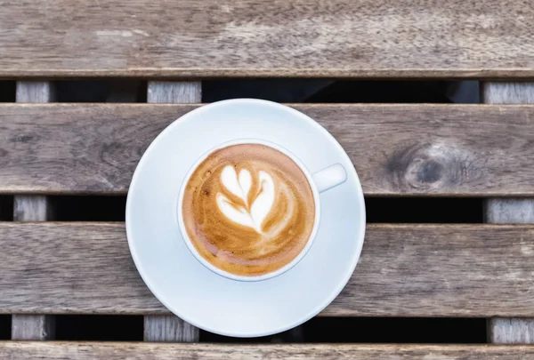 Cup of fresh cappuchino with heart drawn on the foam