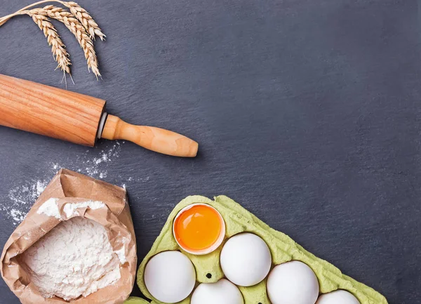 Cozimento ingredientes e ferramentas no fundo de pedra preta — Fotografia de Stock