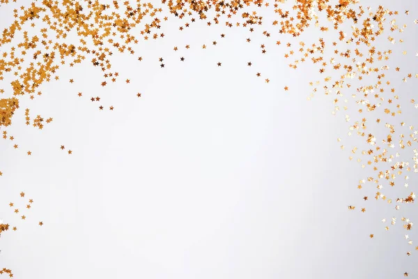 Golden glitter decor on the white background with copy space — Stock Photo, Image