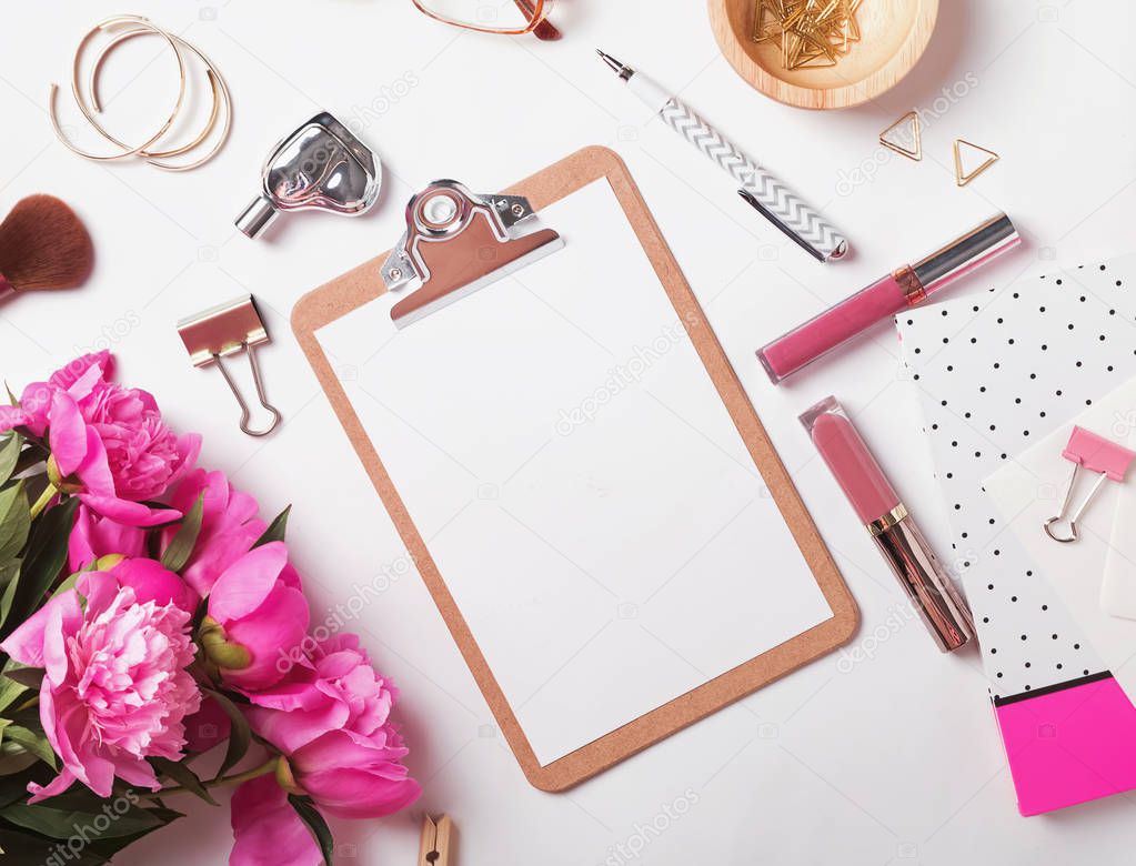 Clipboard mock-up on the  feminine workplace with peonies and stationary