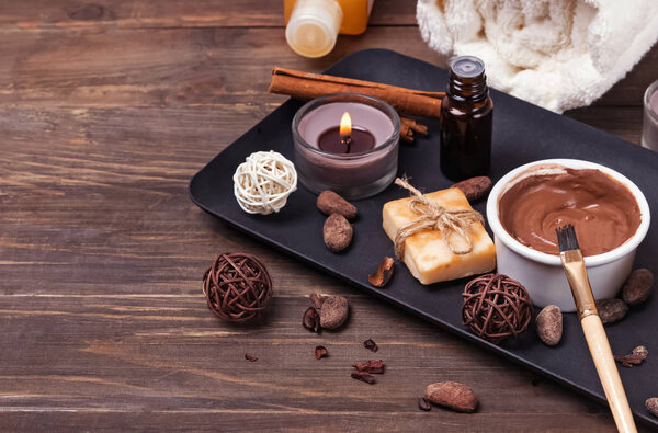 Chocolate spa set on the wooden background, close-up.