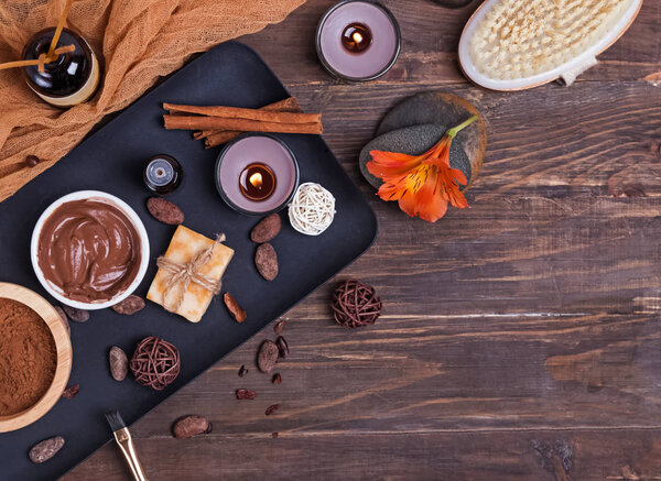 Chocolate spa set on the wooden background, top view.