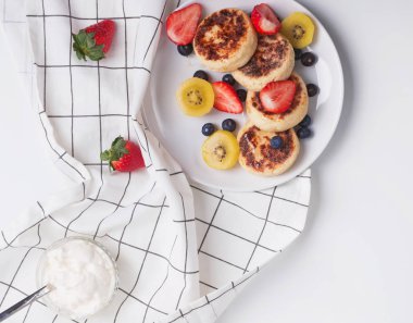 Süzme peynir pankeas beyaz plaka üzerinde çilek ile