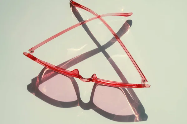 Stylish feminine cat eye sunglasses on the white table — Stock Photo, Image