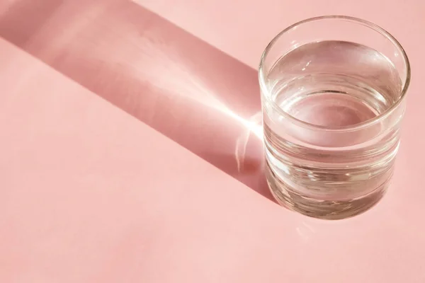 A glass of water isolated on pink background — Stock Photo, Image