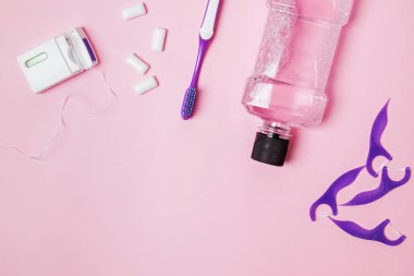 Pembe arka planda diş bakım aksesuarları