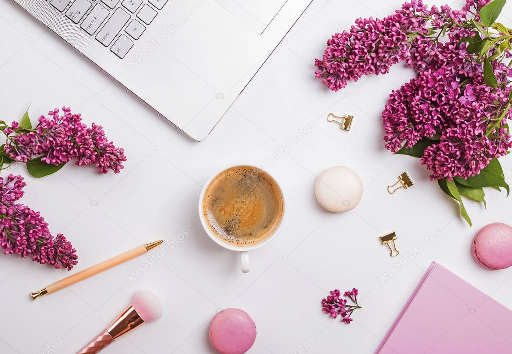 Modern feminine workplace with coffee and flowers