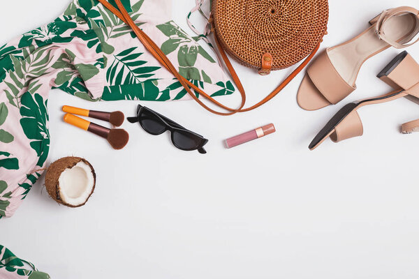 Dress, sandals, hat and other stylish accessories on white background