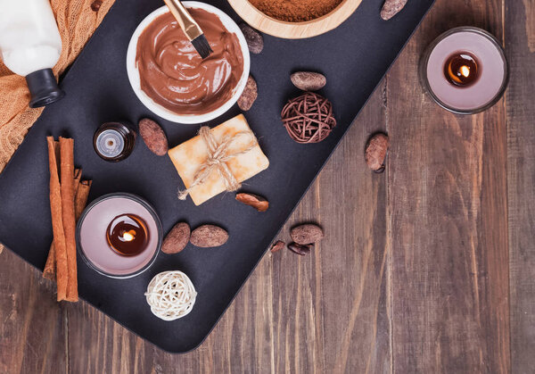 Chocolate spa set on the wooden background, top view.